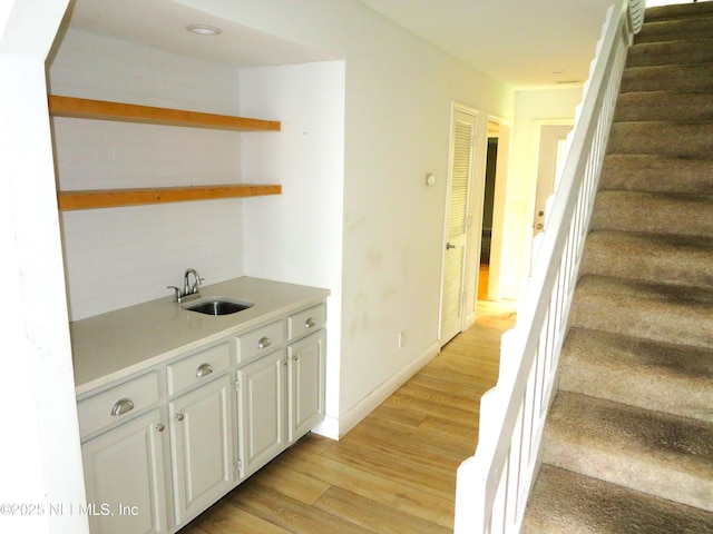29 Fox Valley Dr, Orange Park, FL 32073 - bar with tasteful backsplash, stairway, baseboards, a sink, and light wood-style floors