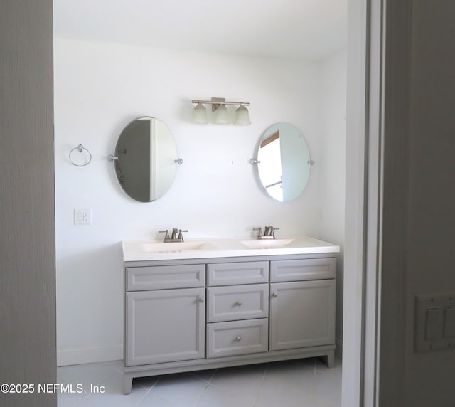 29 Fox Valley Dr, Orange Park, FL 32073 - bathroom featuring baseboards, double vanity, a sink, and tile patterned floors