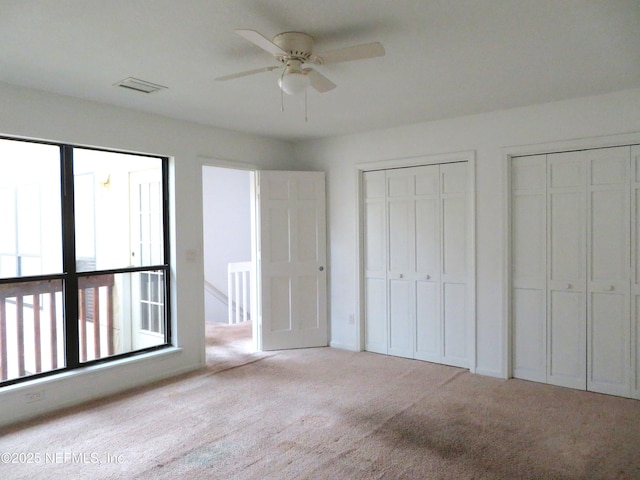 29 Fox Valley Dr, Orange Park, FL 32073 - unfurnished bedroom with ceiling fan, carpet, multiple closets, and visible vents