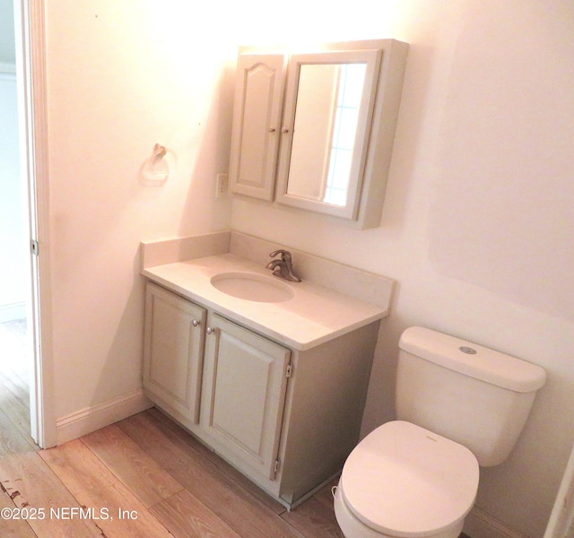 29 Fox Valley Dr, Orange Park, FL 32073 - bathroom featuring baseboards, wood finished floors, toilet, and vanity