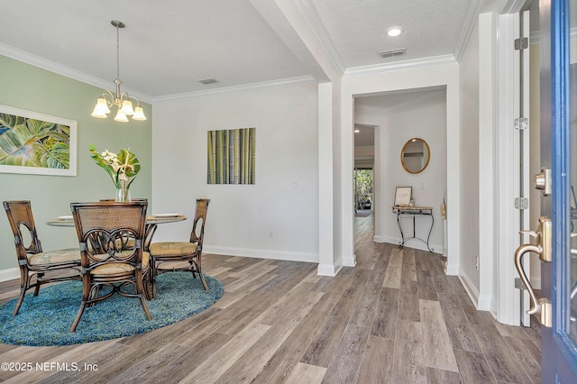 699 Aspen Leaf Dr, Jacksonville, FL 32081 - dining area with ornamental molding, visible vents, a notable chandelier, and wood finished floors