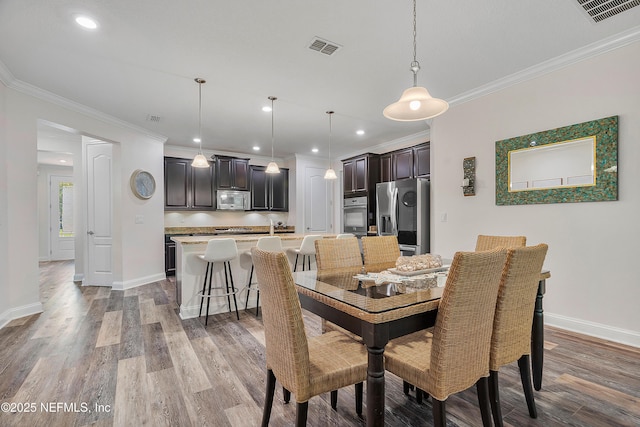699 Aspen Leaf Dr, Jacksonville, FL 32081 - dining area featuring light wood-style flooring, crown molding, baseboards, and visible vents