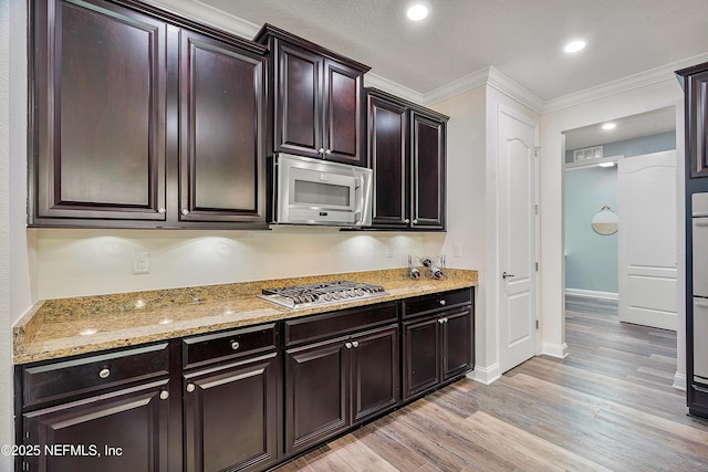 699 Aspen Leaf Dr, Jacksonville, FL 32081 - kitchen with light stone countertops, ornamental molding, stainless steel appliances, recessed lighting, and light wood-type flooring
