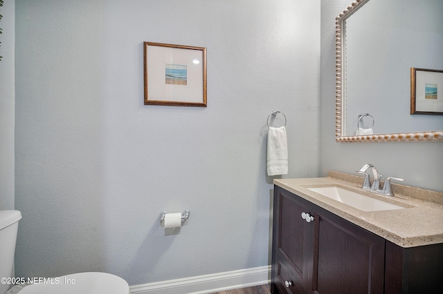699 Aspen Leaf Dr, Jacksonville, FL 32081 - bathroom with baseboards, toilet, and vanity