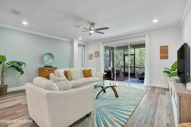 699 Aspen Leaf Dr, Jacksonville, FL 32081 - living room featuring wood finished floors, visible vents, crown molding, and ceiling fan
