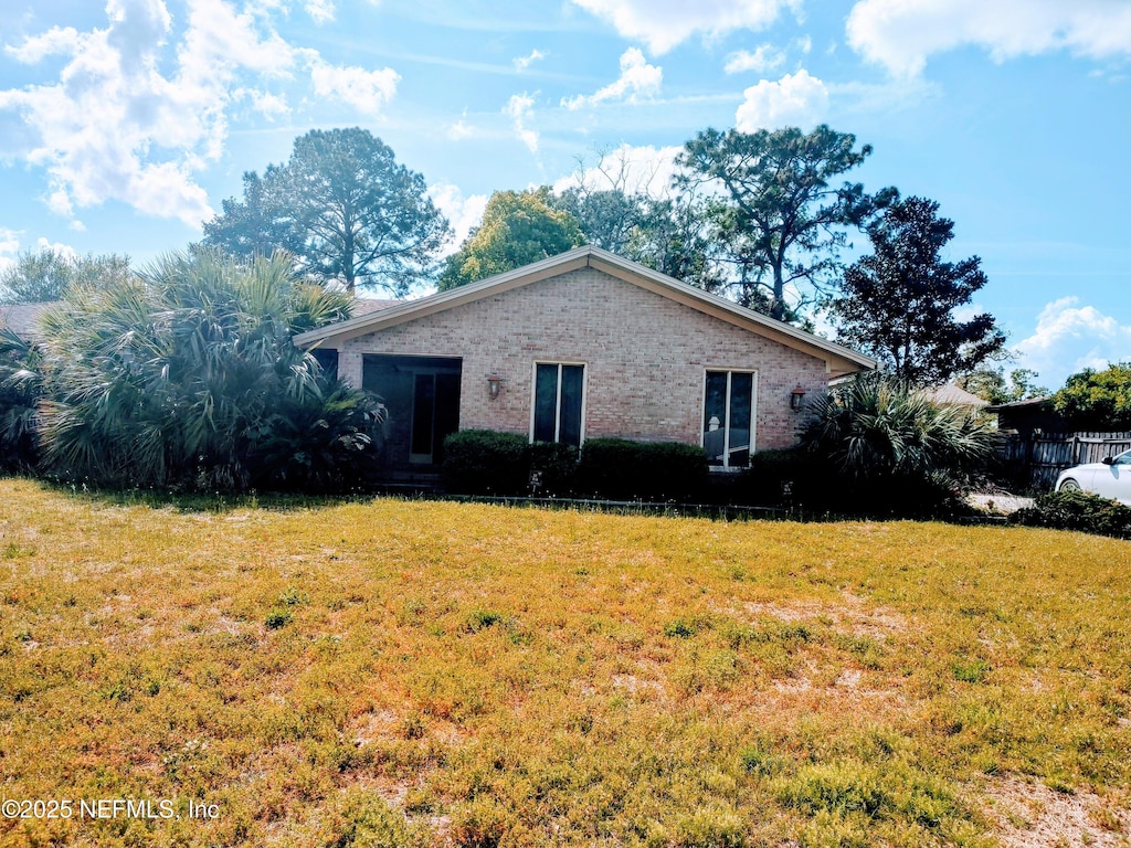 3318 Sara Dr, Jacksonville, FL 32277 - view of front of property featuring brick siding and a front yard