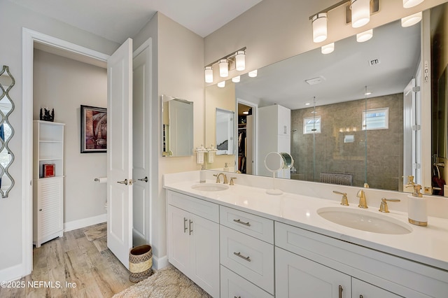 598 Marquesa Cir, Saint Johns, FL 32259 - bathroom featuring double vanity, a sink, wood finished floors, and a shower stall