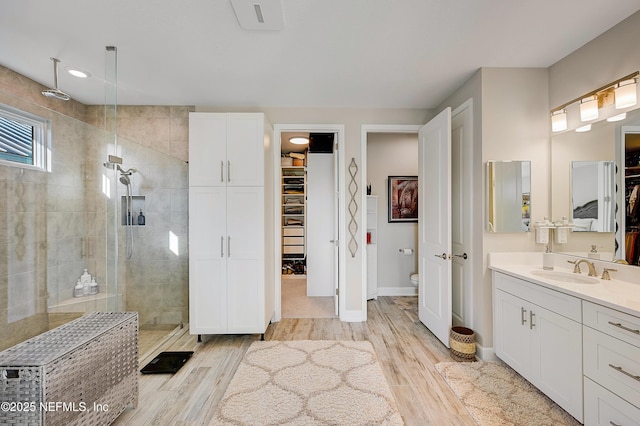 598 Marquesa Cir, Saint Johns, FL 32259 - bathroom with vanity, a walk in shower, toilet, baseboards, and wood finished floors