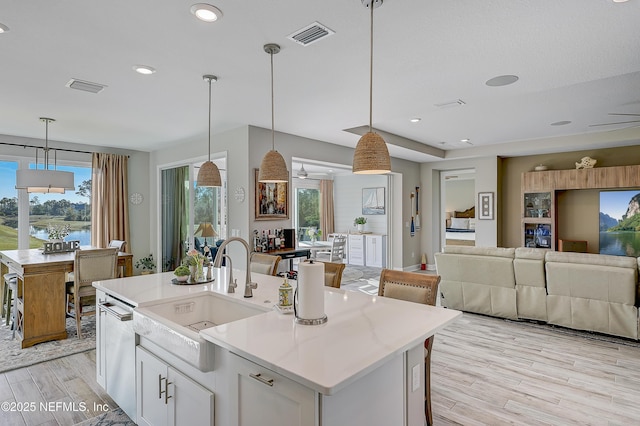 598 Marquesa Cir, Saint Johns, FL 32259 - kitchen featuring visible vents, a sink, light wood-style floors, and open floor plan