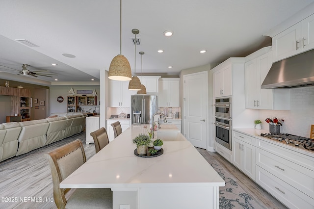 598 Marquesa Cir, Saint Johns, FL 32259 - kitchen with under cabinet range hood, visible vents, a sink, and appliances with stainless steel finishes