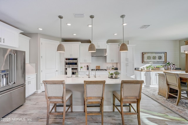 598 Marquesa Cir, Saint Johns, FL 32259 - kitchen with a breakfast bar, decorative backsplash, visible vents, and appliances with stainless steel finishes