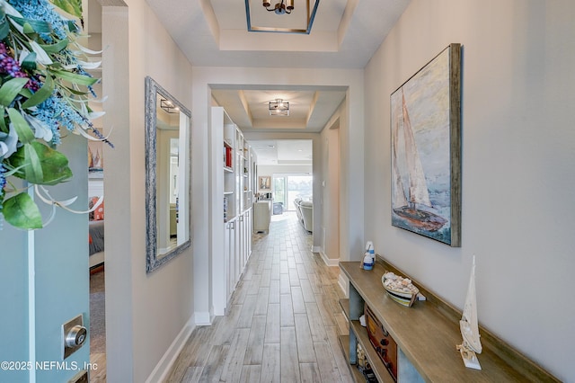 598 Marquesa Cir, Saint Johns, FL 32259 - hall with a tray ceiling, light wood-style floors, and baseboards
