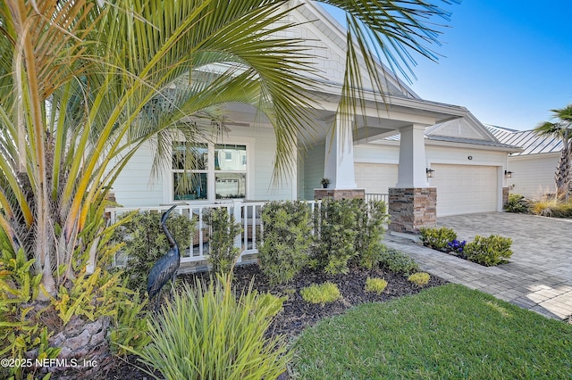 598 Marquesa Cir, Saint Johns, FL 32259 - view of front of house with an attached garage, covered porch, a ceiling fan, and decorative driveway