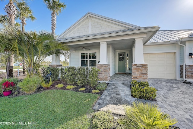 598 Marquesa Cir, Saint Johns, FL 32259 - view of front of house featuring metal roof, stone siding, decorative driveway, a ceiling fan, and a garage