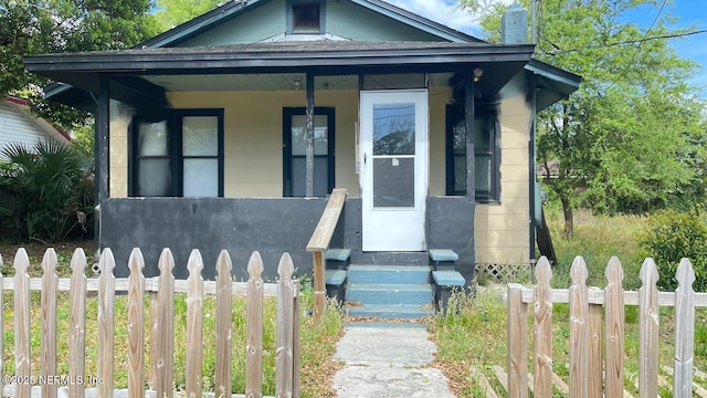 719 Broxton St, Jacksonville, FL 32208 - view of front of property with a porch, a fenced front yard, and entry steps