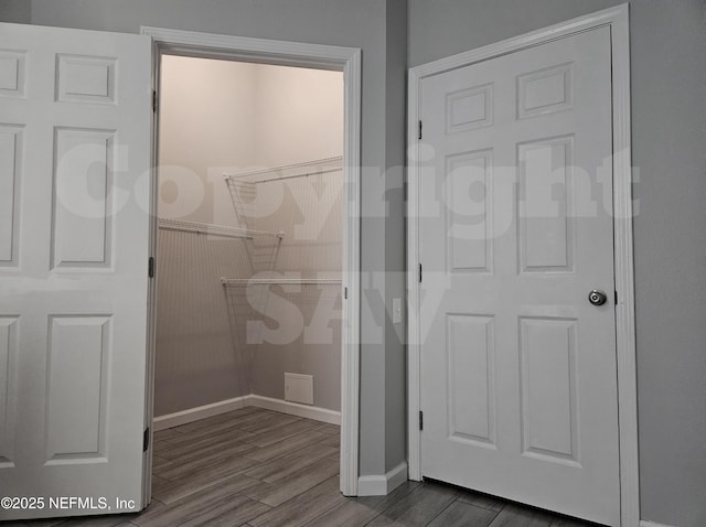 bathroom featuring wood finished floors and baseboards