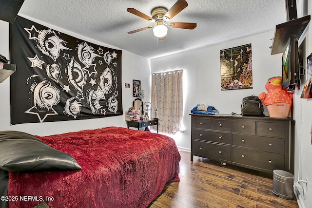 bedroom featuring a textured ceiling, ceiling fan, and dark wood finished floors