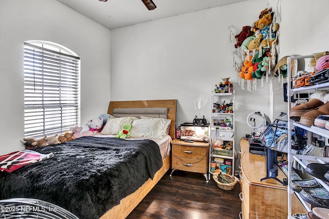 bedroom with dark wood-style floors and a ceiling fan