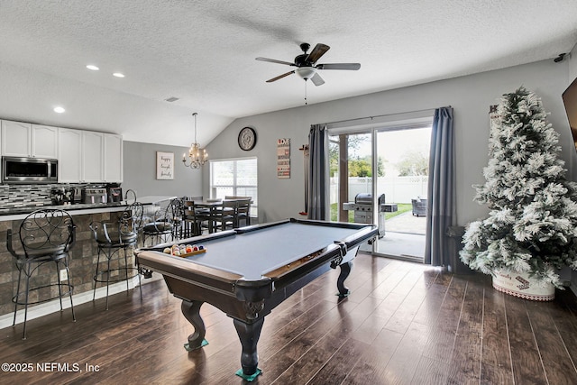 rec room with vaulted ceiling, ceiling fan with notable chandelier, a textured ceiling, dark wood-style floors, and pool table