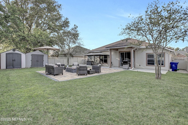 rear view of house with a patio area, a gazebo, a storage shed, outdoor lounge area, and a fenced backyard