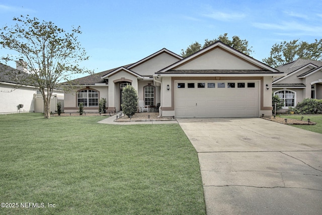 ranch-style home featuring a front lawn, stucco siding, a garage, and concrete driveway