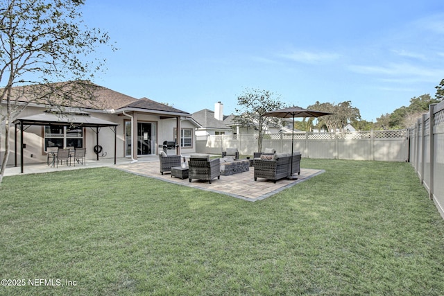 view of yard featuring a fenced backyard, an outdoor hangout area, a gazebo, and a patio area