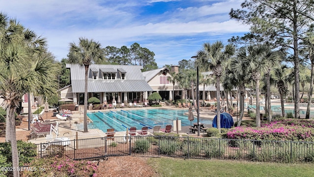 community pool featuring a patio and fence