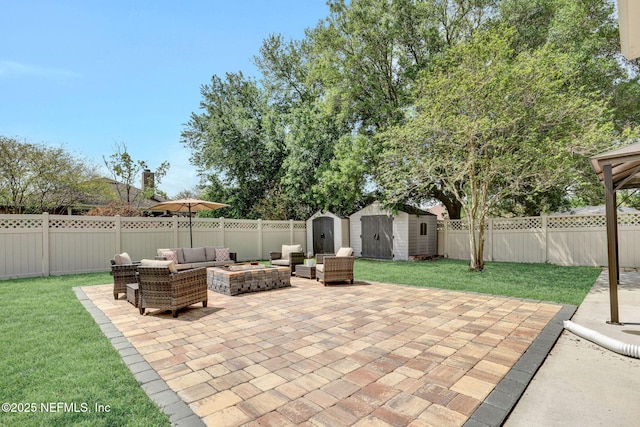 view of patio featuring a fenced backyard, an outdoor living space with a fire pit, an outbuilding, and a shed