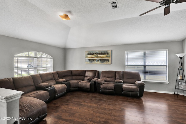 living area featuring visible vents, baseboards, ceiling fan, wood finished floors, and lofted ceiling