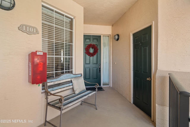 entrance to property featuring stucco siding