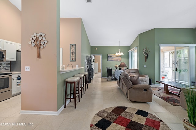 living area featuring baseboards, high vaulted ceiling, an inviting chandelier, and light tile patterned floors