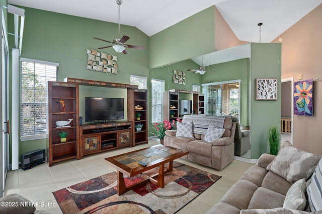 living area with tile patterned floors, plenty of natural light, and ceiling fan