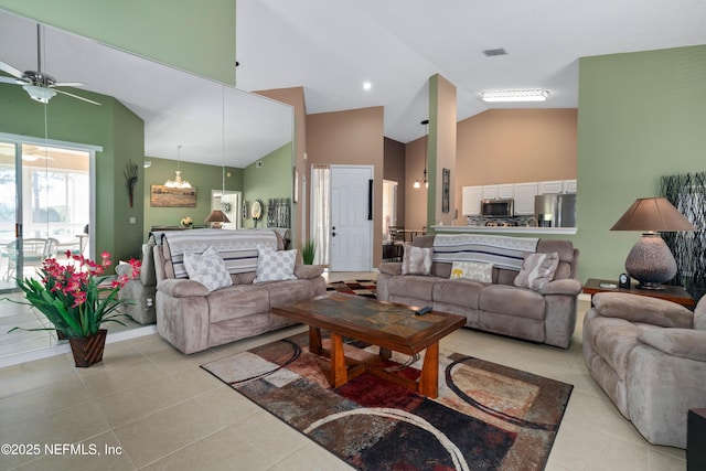 living area with high vaulted ceiling, visible vents, a ceiling fan, and light tile patterned floors
