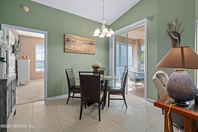 dining area featuring light tile patterned floors, baseboards, vaulted ceiling, and a notable chandelier