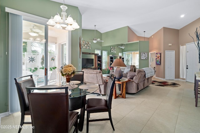dining area featuring light tile patterned floors, plenty of natural light, and ceiling fan with notable chandelier