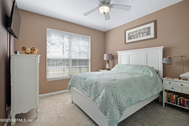 bedroom with baseboards, a ceiling fan, and light colored carpet