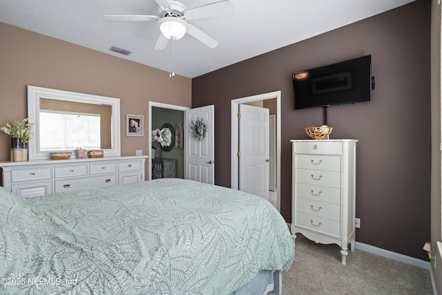 carpeted bedroom with baseboards, ceiling fan, and visible vents