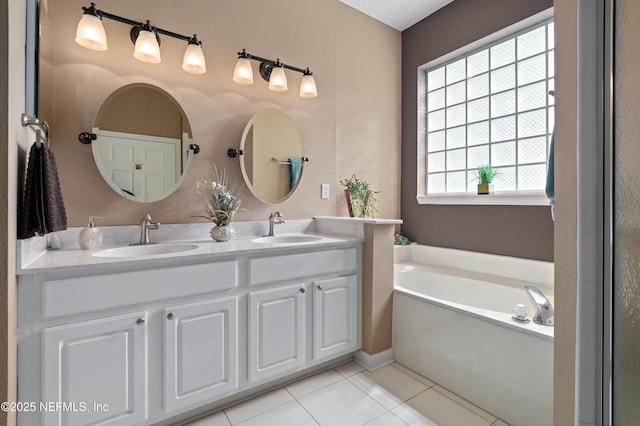 full bath featuring a garden tub, double vanity, a sink, and tile patterned floors