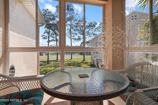 sunroom / solarium featuring outdoor dining space