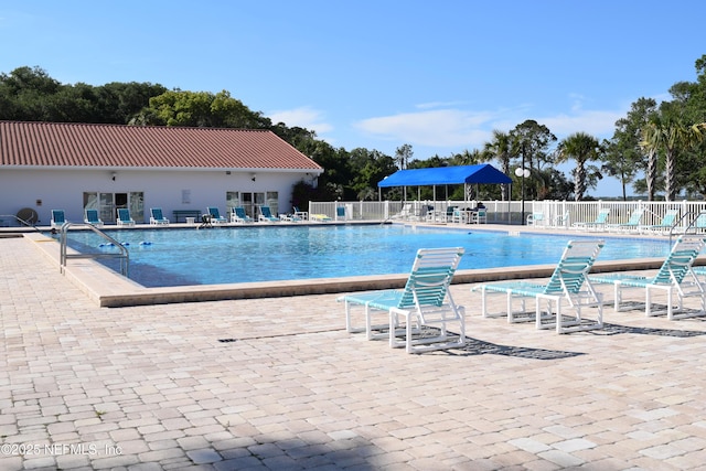 pool featuring fence and a patio