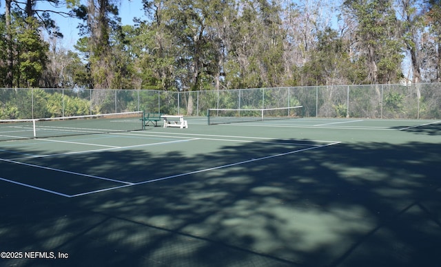 view of sport court featuring fence