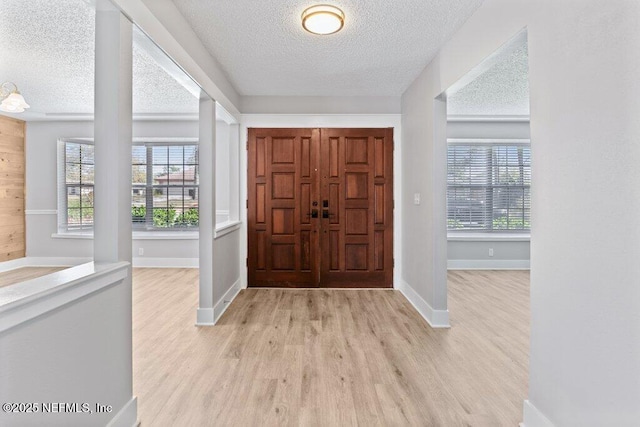 1967 Sussex Dr S, Orange Park, FL 32073 - entryway featuring light wood-style flooring, plenty of natural light, and a textured ceiling