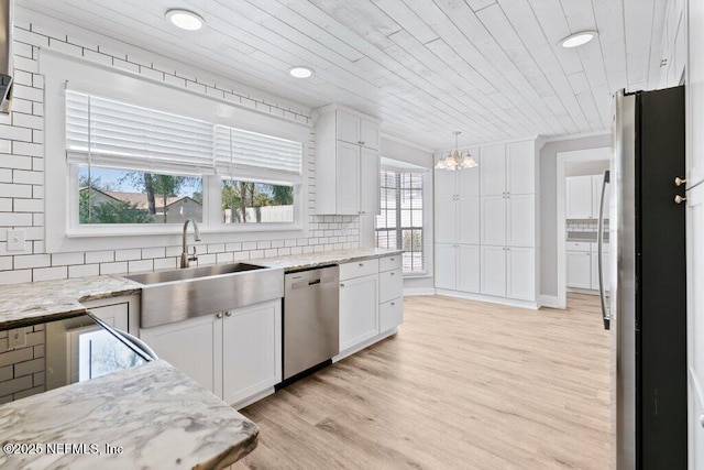 1967 Sussex Dr S, Orange Park, FL 32073 - kitchen with white cabinetry, a sink, stainless steel appliances, and a notable chandelier