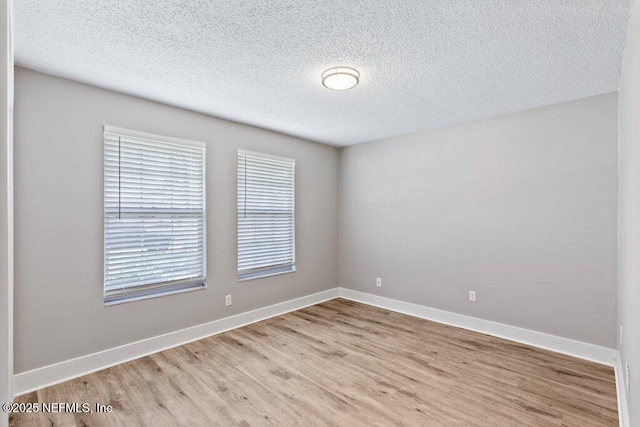 1967 Sussex Dr S, Orange Park, FL 32073 - unfurnished room featuring baseboards, a textured ceiling, and wood finished floors