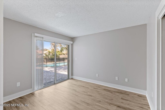 1967 Sussex Dr S, Orange Park, FL 32073 - spare room with a textured ceiling, baseboards, and wood finished floors