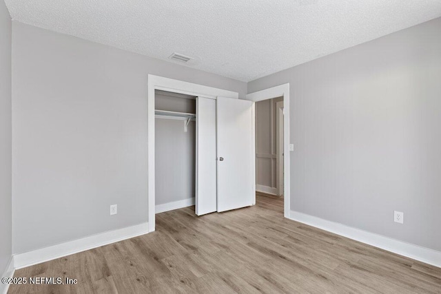 1967 Sussex Dr S, Orange Park, FL 32073 - unfurnished bedroom with baseboards, visible vents, a closet, and wood finished floors