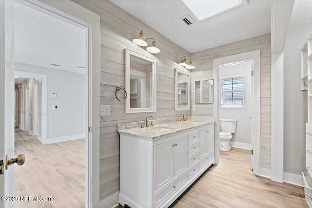 1967 Sussex Dr S, Orange Park, FL 32073 - full bathroom with toilet, a sink, wooden walls, and wood finished floors