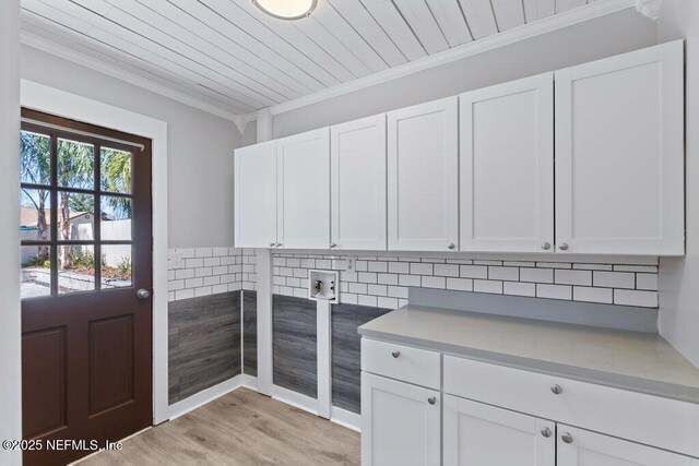 1967 Sussex Dr S, Orange Park, FL 32073 - laundry room featuring wooden ceiling, cabinet space, crown molding, and light wood finished floors