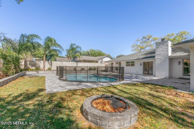 1967 Sussex Dr S, Orange Park, FL 32073 - view of yard with an outdoor fire pit, a fenced backyard, a fenced in pool, french doors, and a patio area