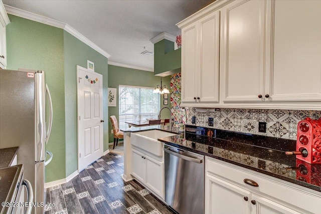 10961 Burnt Mill Rd Unit 1428, Jacksonville, FL 32256 - kitchen featuring crown molding, a sink, backsplash, appliances with stainless steel finishes, and dark wood-style floors